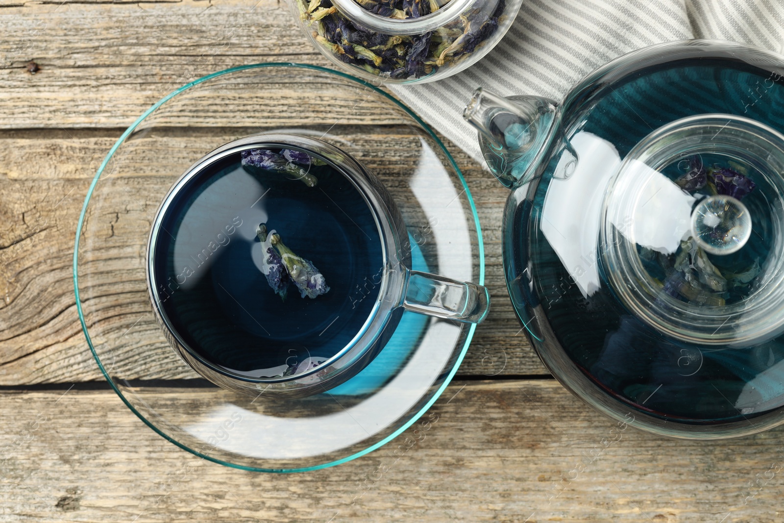 Photo of Delicious butterfly pea flower tea on wooden table, flat lay