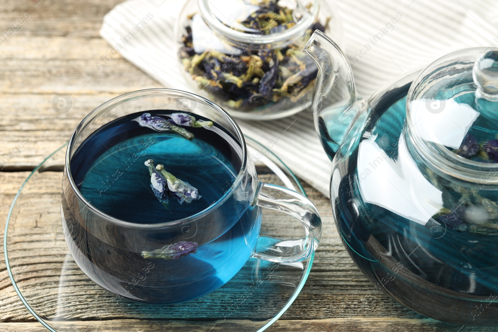 Photo of Delicious butterfly pea flower tea on wooden table, closeup