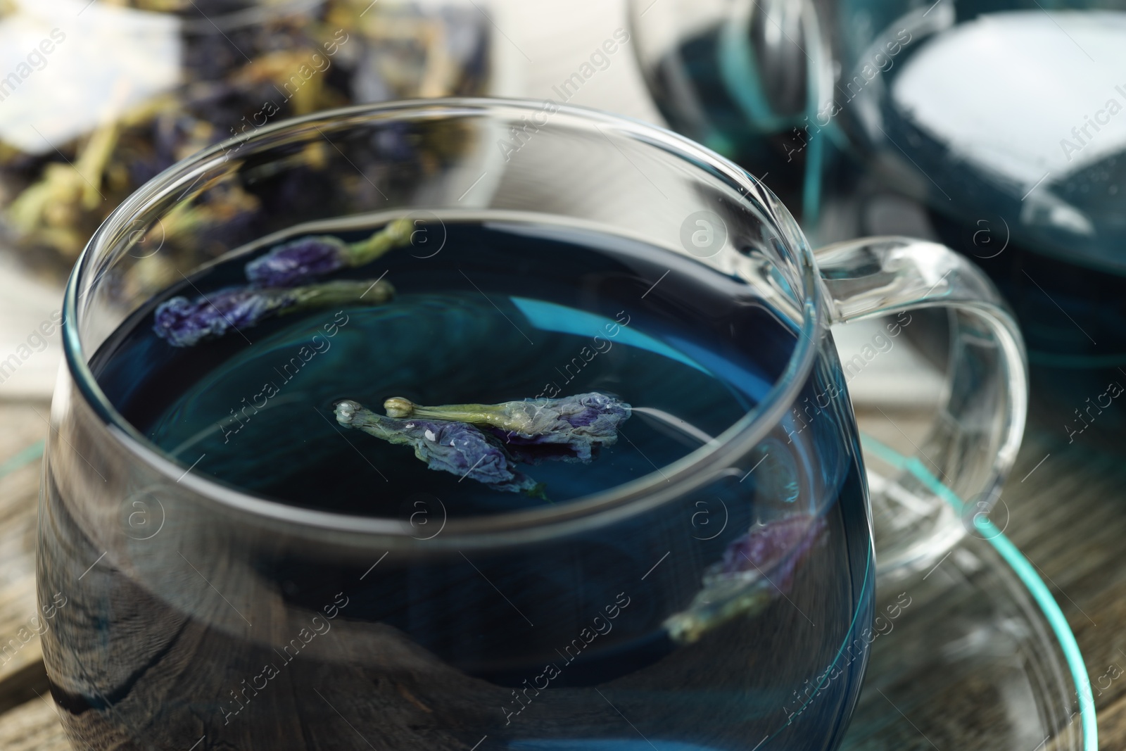 Photo of Delicious butterfly pea flower tea on table, closeup