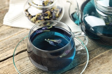 Photo of Delicious butterfly pea flower tea on wooden table, closeup