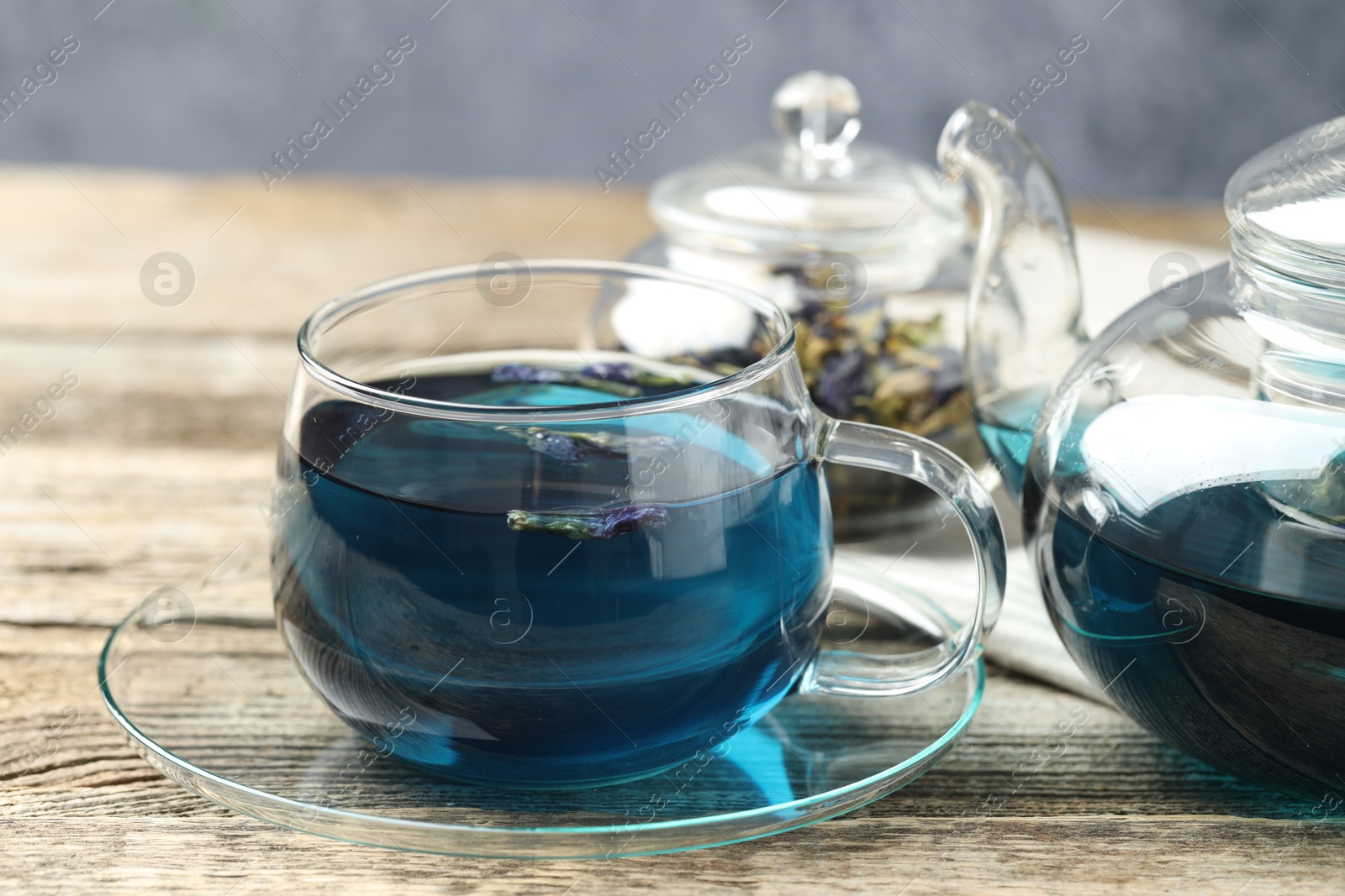 Photo of Delicious butterfly pea flower tea on wooden table, closeup