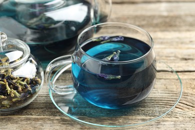 Photo of Delicious butterfly pea flower tea on wooden table, closeup