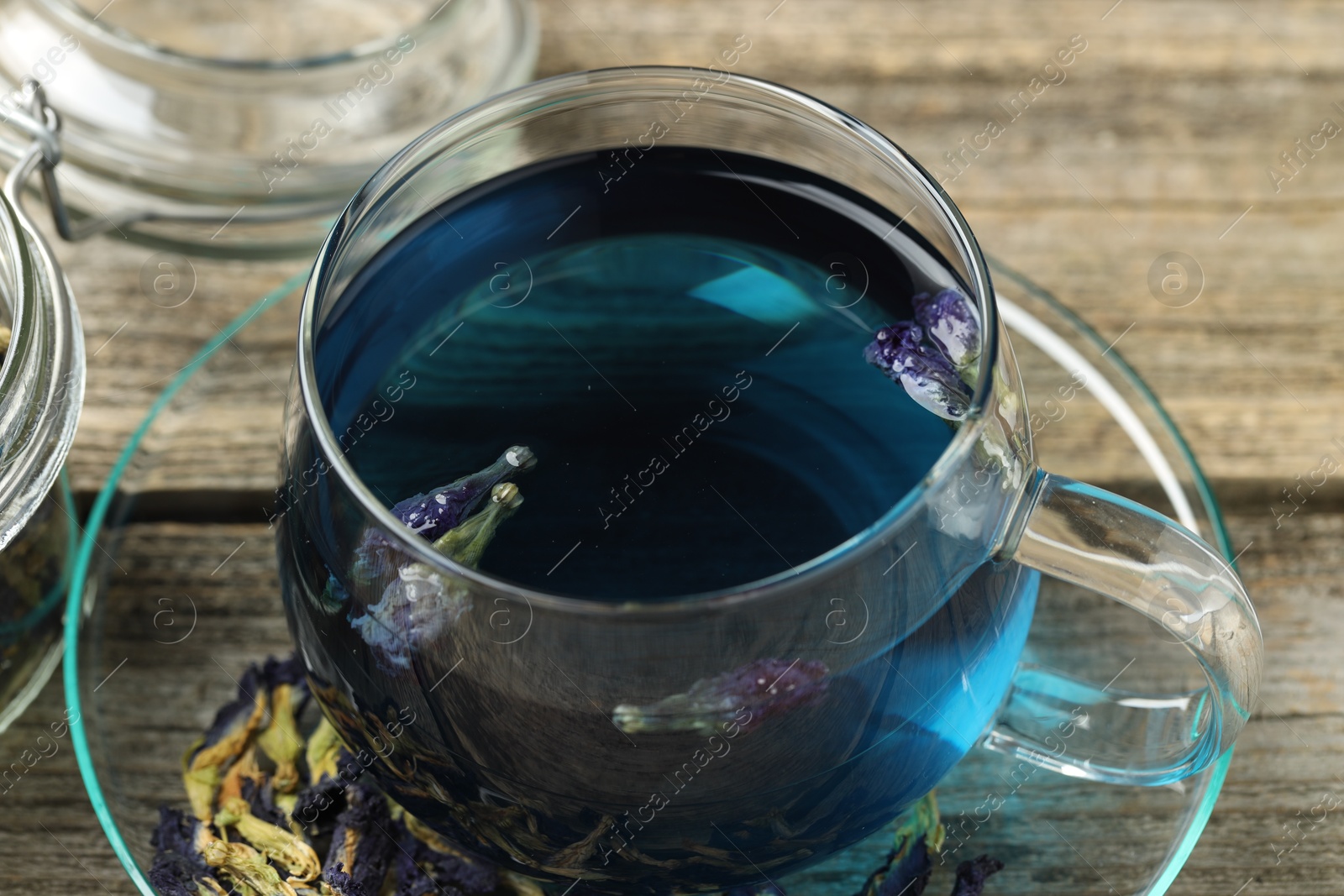 Photo of Delicious butterfly pea flower tea on wooden table, closeup