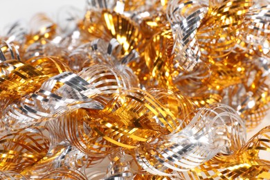 Photo of Beautiful shiny tinsel as background, closeup view