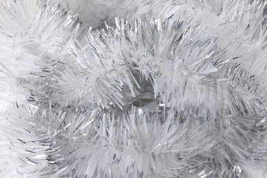 Photo of Shiny white tinsel as background, closeup view