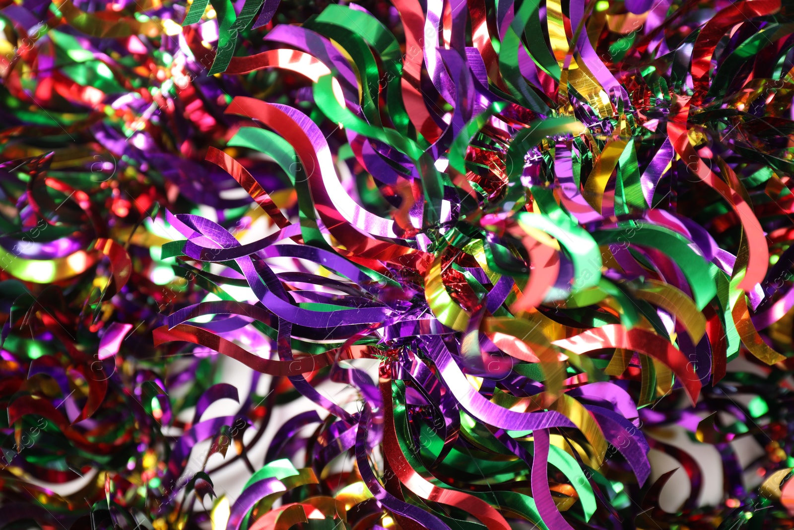 Photo of Many colorful tinsels as background, closeup view