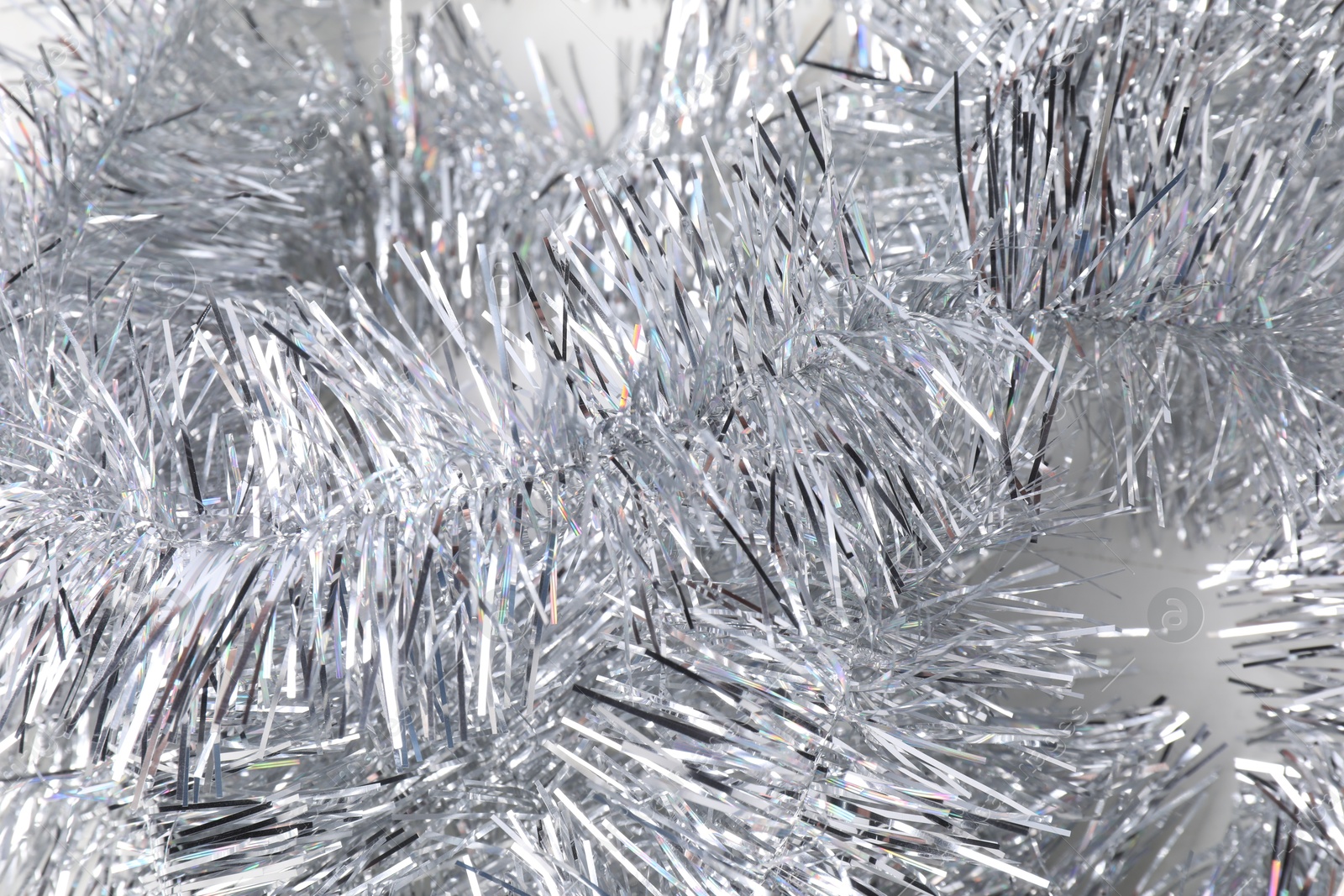 Photo of Shiny silver tinsel as background, closeup view