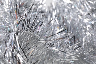 Photo of Shiny silver tinsel as background, closeup view