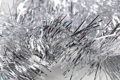 Photo of Shiny silver tinsel as background, closeup view