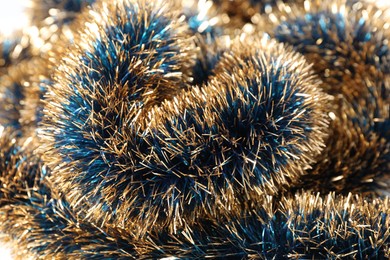 Photo of Beautiful shiny tinsel as background, closeup view