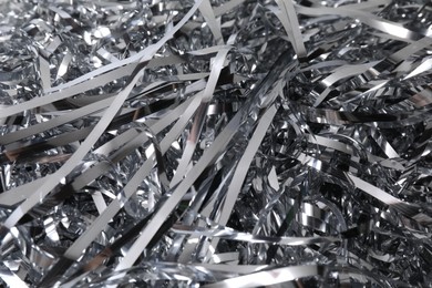 Photo of Shiny silver tinsel as background, closeup view