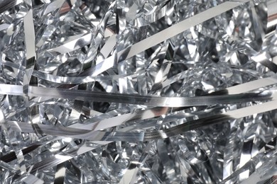 Photo of Shiny silver tinsel as background, closeup view