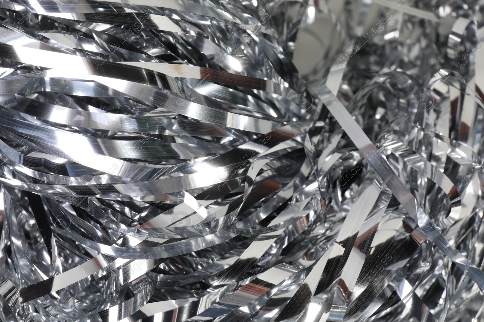 Photo of Shiny silver tinsel as background, closeup view