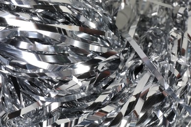 Photo of Shiny silver tinsel as background, closeup view