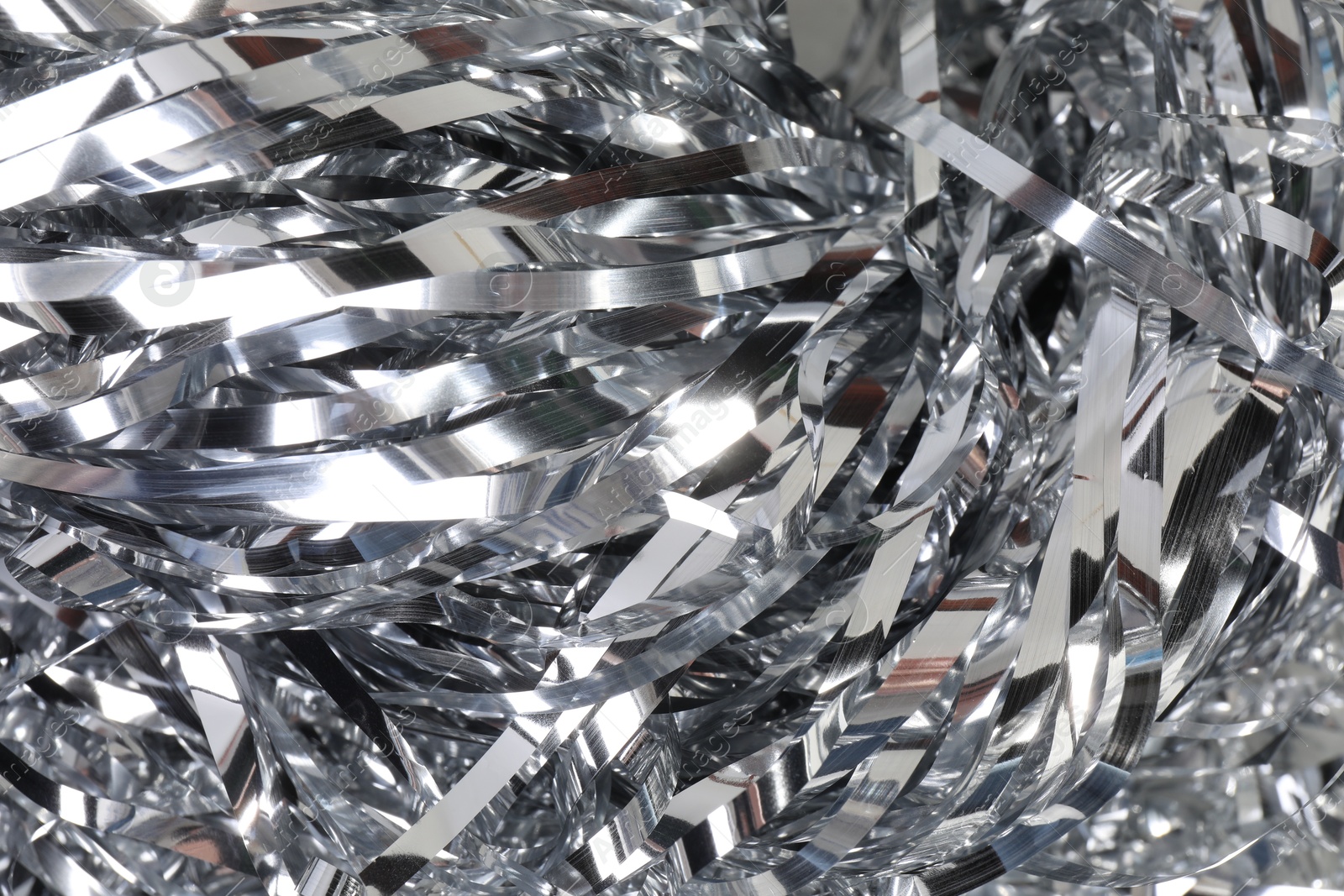 Photo of Shiny silver tinsel as background, closeup view