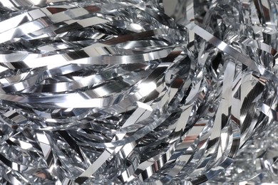 Photo of Shiny silver tinsel as background, closeup view