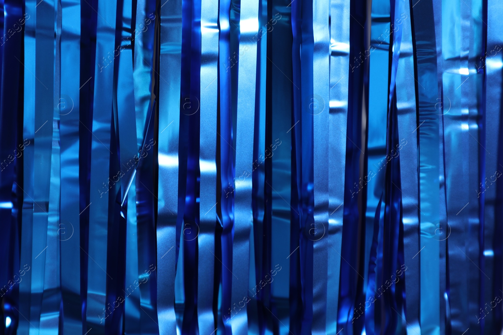 Photo of Shiny blue tinsel as background, closeup view