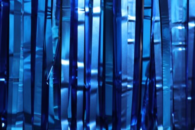 Photo of Shiny blue tinsel as background, closeup view