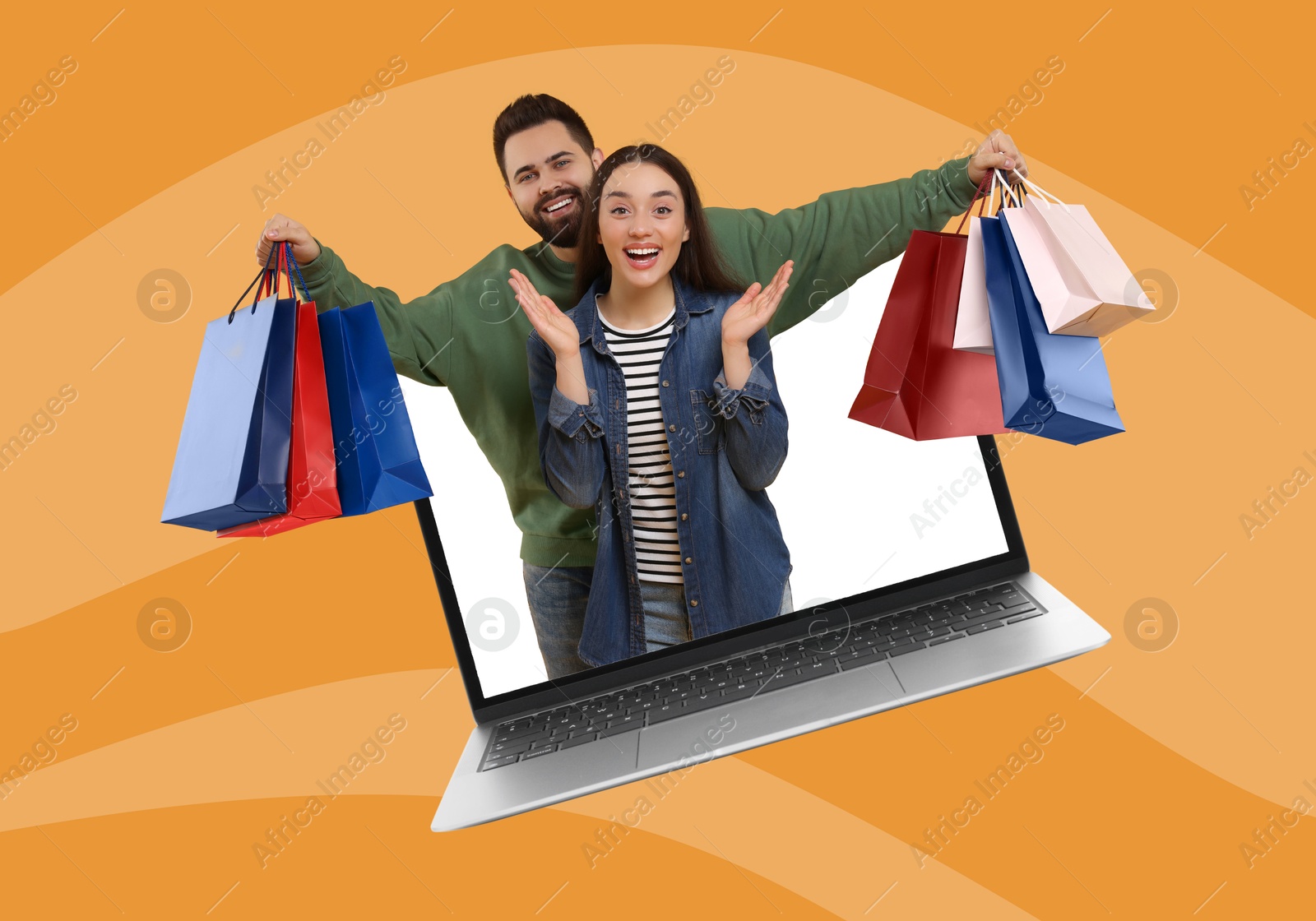 Image of Internet shopping. Happy couple with shopping bags coming out of laptop on striped orange background