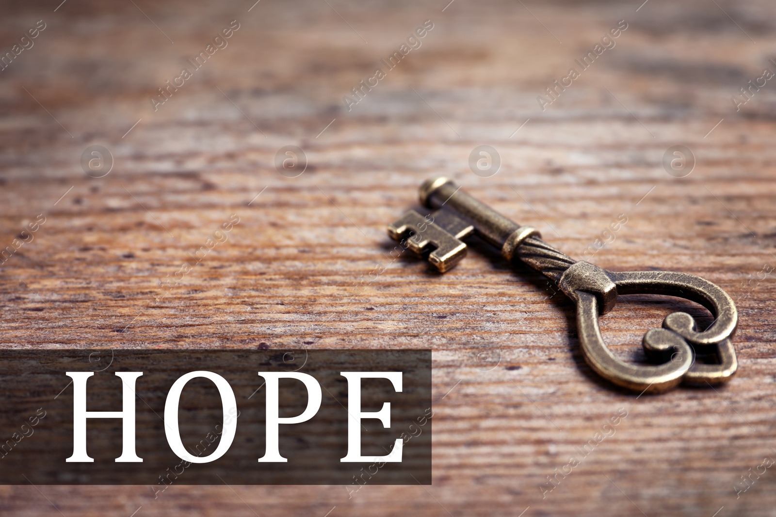 Image of Hope. Old vintage key on wooden background