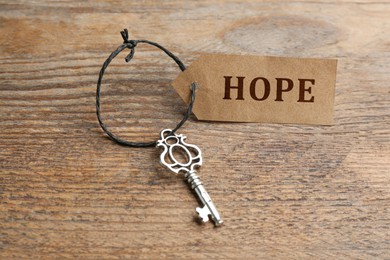 Image of Vintage key and tag wIth word Hope on wooden table