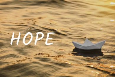 Image of Hope. Paper boat floating on water outdoors