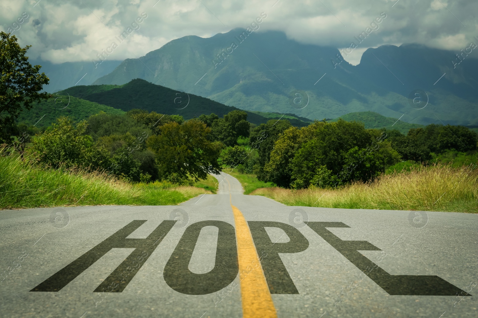 Image of Word Hope on asphalt road leading to mountains