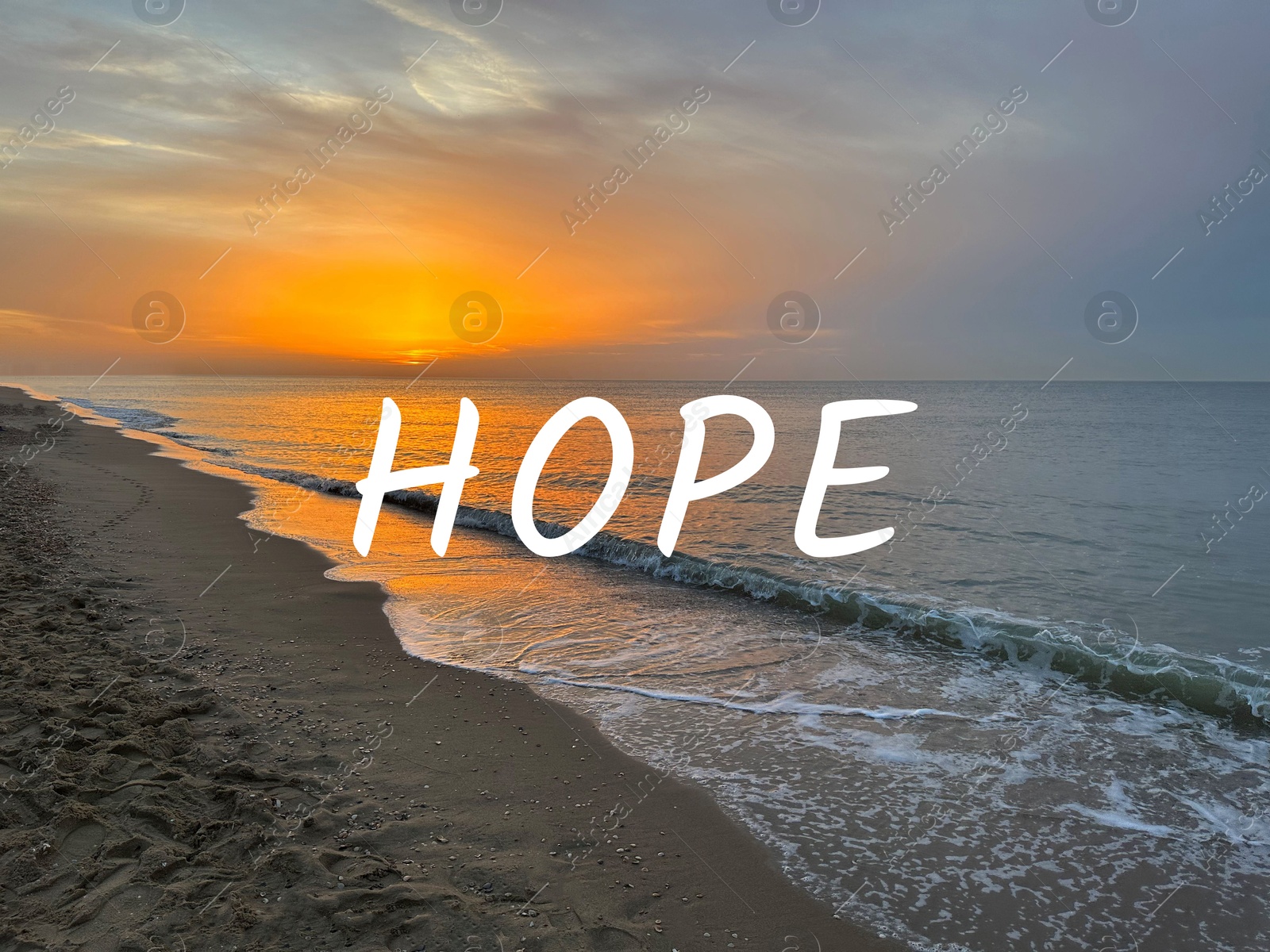 Image of Hope. Sea waves rolling onto sandy beach at sunrise