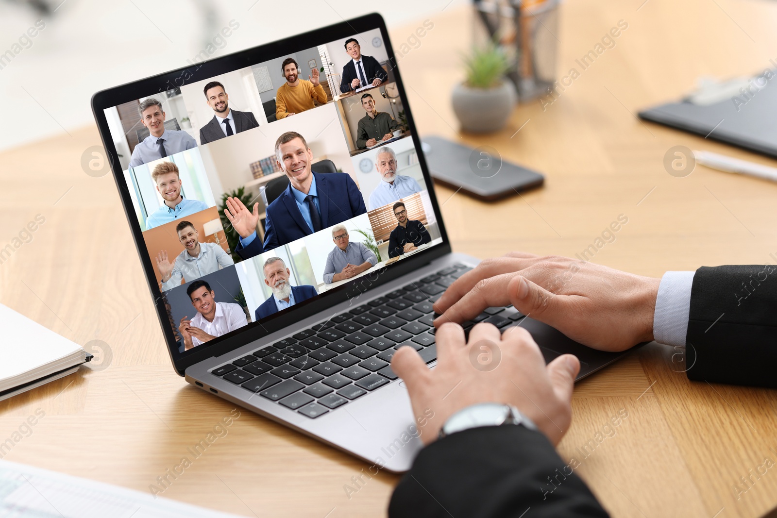 Image of Business meeting. Man using laptop during online video chat at table, closeup