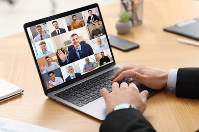 Image of Business meeting. Man using laptop during online video chat at table, closeup