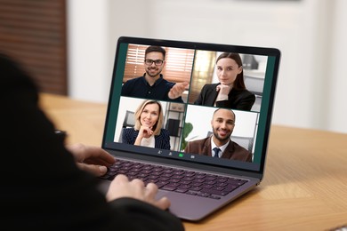 Image of Business meeting. Woman using laptop during online video chat at table, closeup