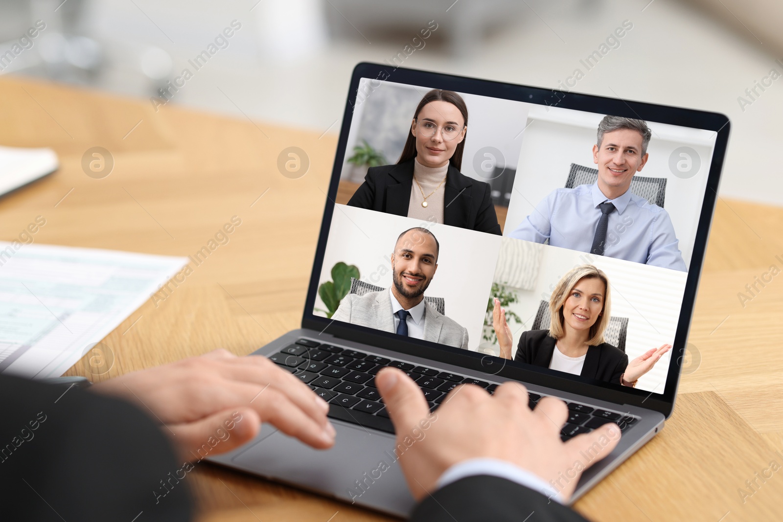 Image of Business meeting. Man using laptop during online video chat at table, closeup