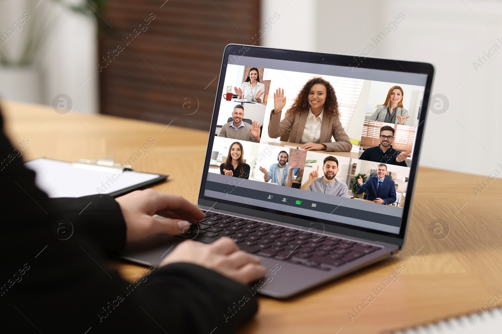 Image of Business meeting. Woman using laptop during online video chat at table, closeup