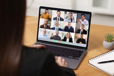 Business meeting. Woman using laptop during online video chat at table, closeup