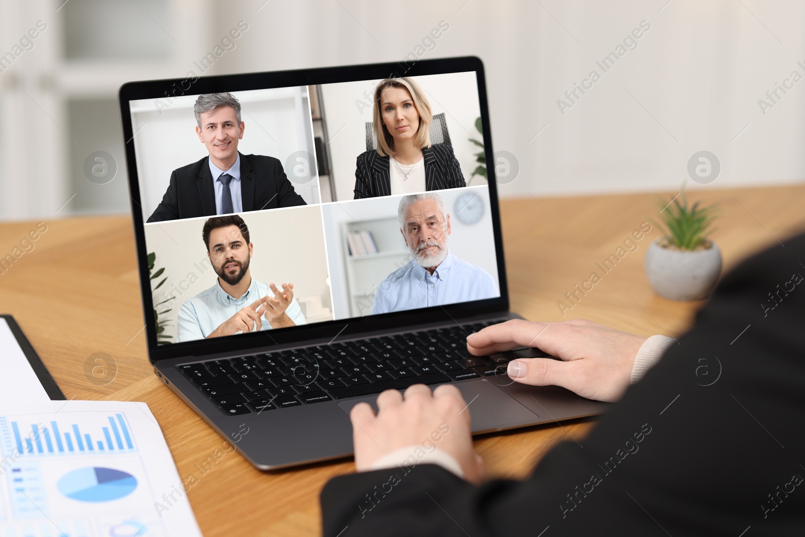 Image of Business meeting. Woman using laptop during online video chat at table, closeup