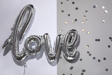 Photo of Foil balloon in shape of word LOVE on color background, top view