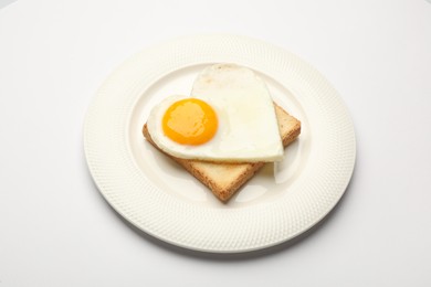 Plate with tasty fried egg in shape of heart and toast isolated on white