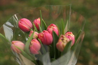 Photo of Beautiful bouquet of tulip flowers outdoors, closeup