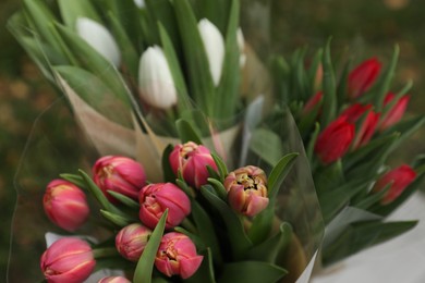 Photo of Beautiful bouquets of colorful tulips outdoors, closeup