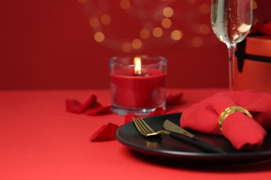 Photo of Beautiful table setting with burning candle for romantic dinner, closeup. Space for text