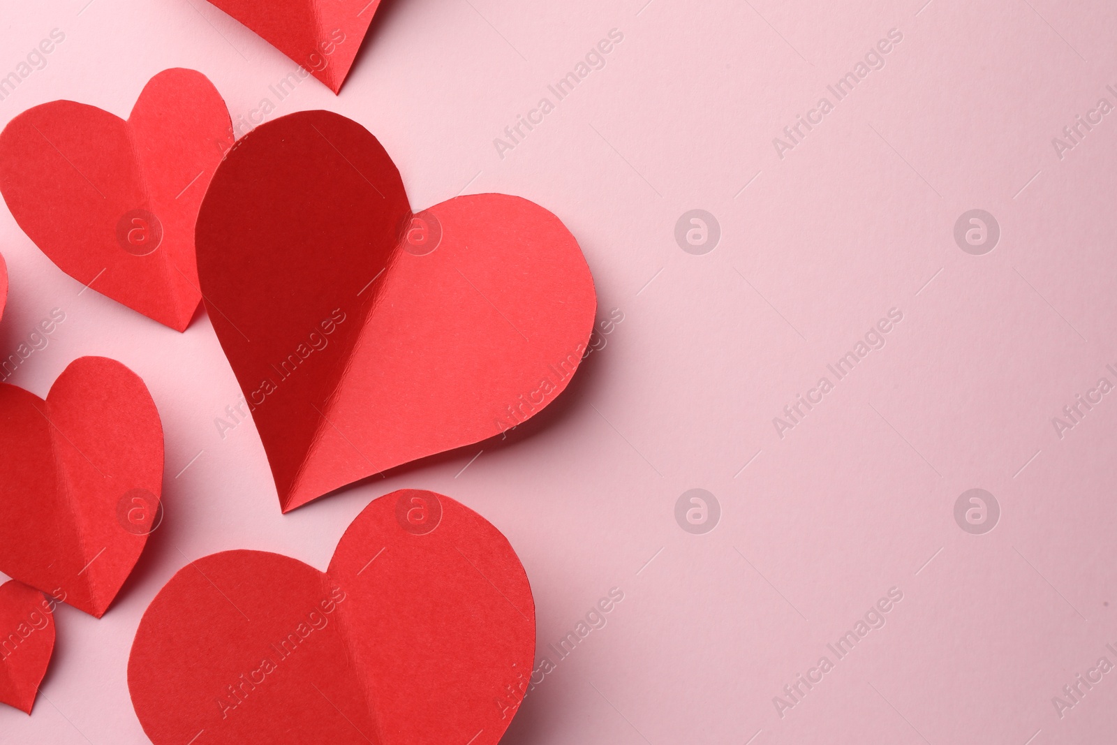 Photo of Paper hearts on pink background, flat lay. Space for text