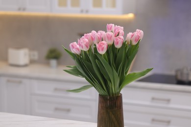 Photo of Beautiful bouquet of fresh pink tulips in kitchen