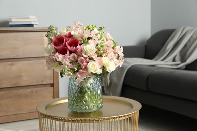 Photo of Beautiful bouquet of fresh flowers on coffee table in room, space for text