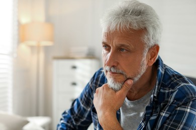 Photo of Sad senior man feeling lonely at home. Space for text