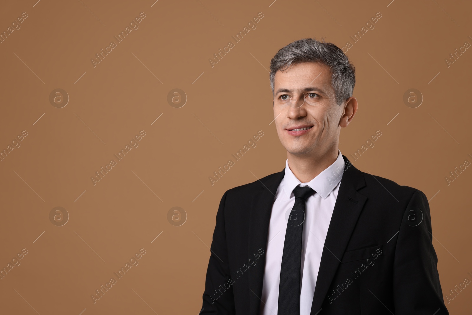 Photo of Portrait of businessman on brown background, space for text