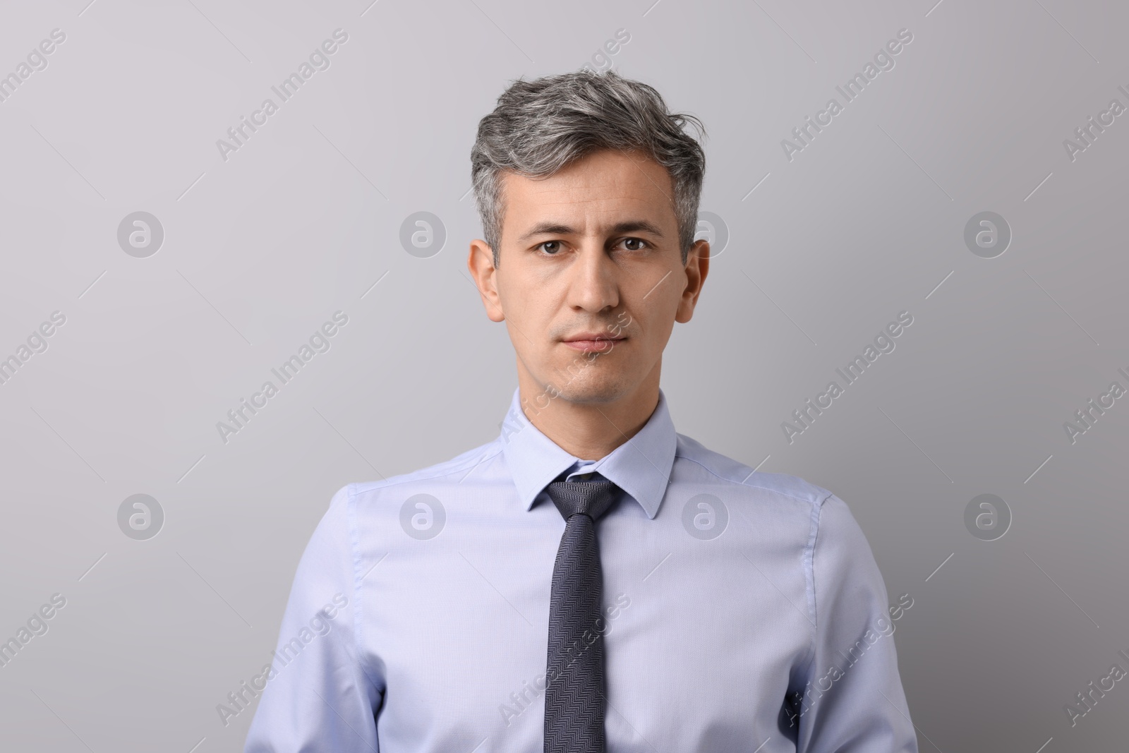 Photo of Portrait of businessman on light grey background