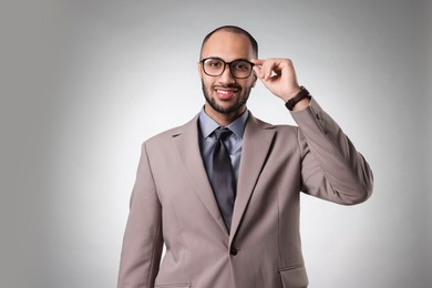 Photo of Portrait of businessman in glasses on light gray background