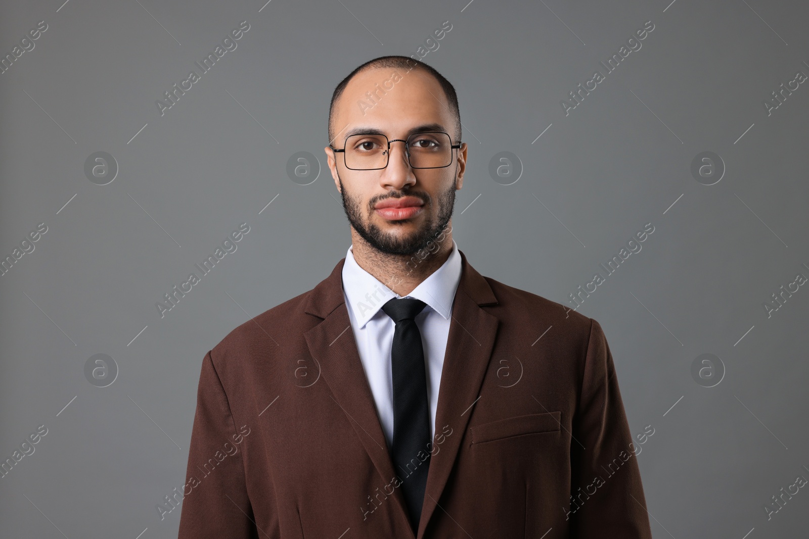 Photo of Portrait of businessman in glasses on gray background