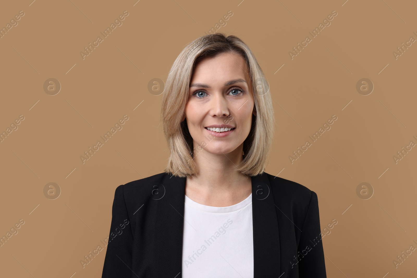 Photo of Portrait of businesswoman in jacket on beige background