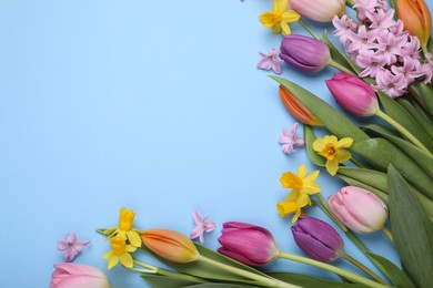 Photo of Beautiful flowers on light blue background, flat lay. Space for text